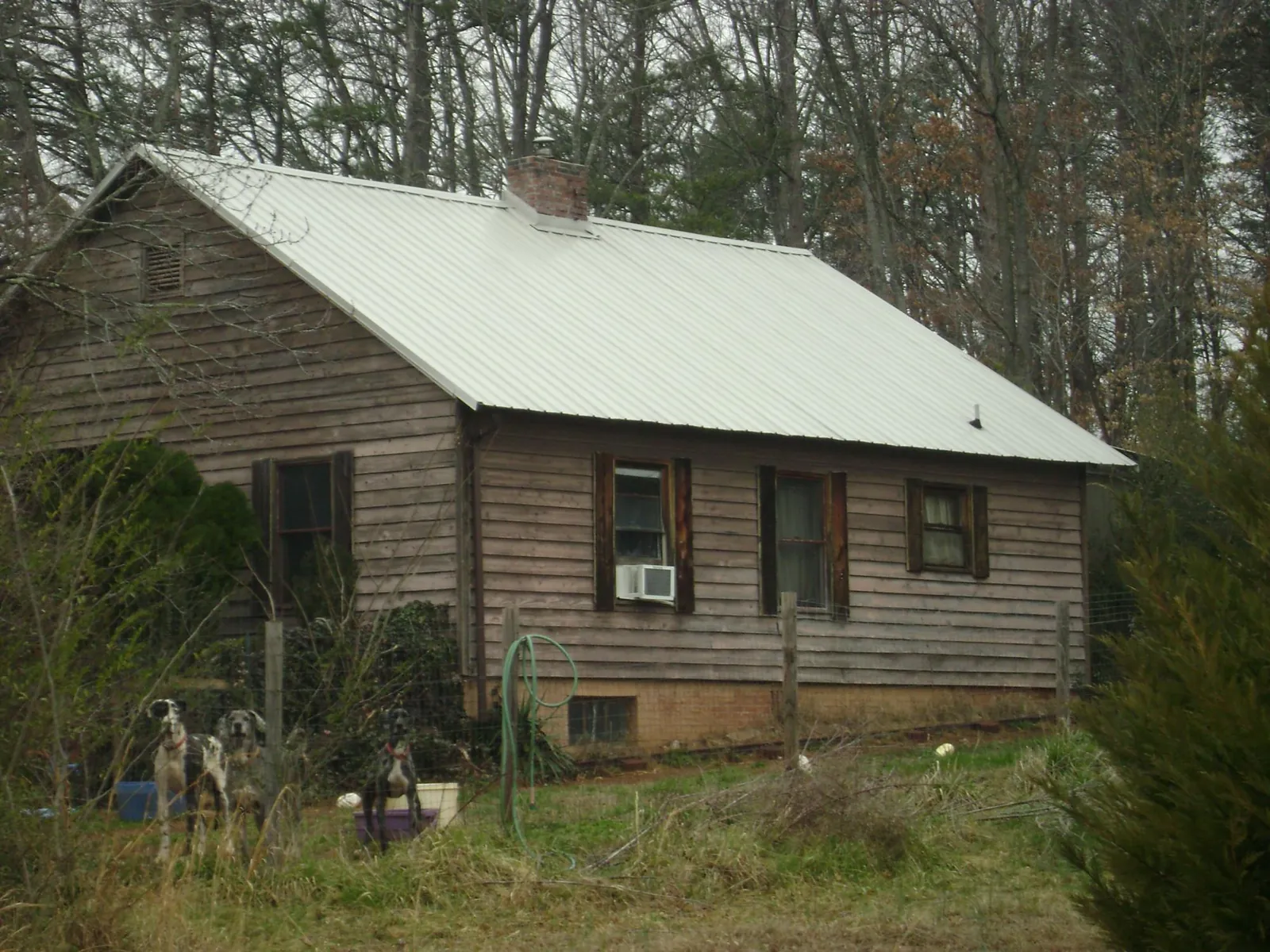 White metal roof on an old wood sided farmhouse, from a Metal Roof Installation job in Rocky Face